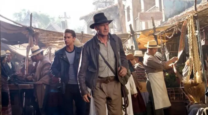 Scene from Indiana Jones and the Kingdom of the Crystal Skull showing a busy marketplace.
Indiana Jones and young man walk through crowded market street