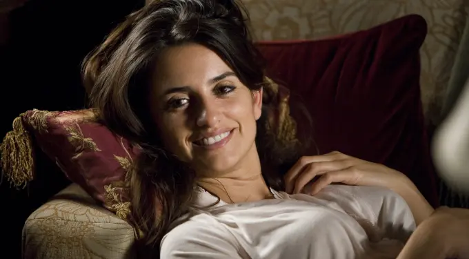 Penélope Cruz reclining on sofa smiling in Elegy movie still