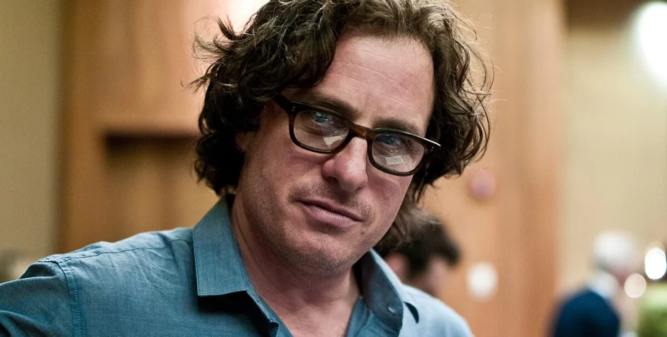 Davis Guggenheim in glasses looks at camera indoors