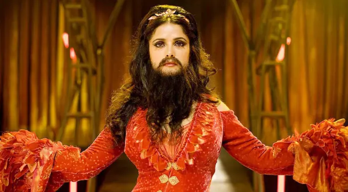Salma Hayek in red costume with fake beard in movie still