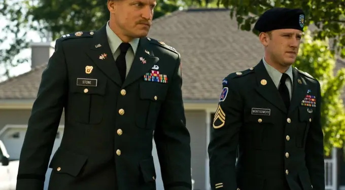 Two men in U.S. Army uniforms walking near suburban house