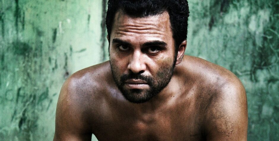 Manny Perez shirtless close-up with intense gaze in La Soga