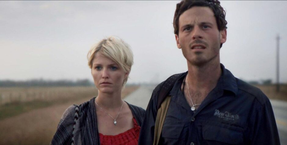 Man and woman walking on rural road looking concerned