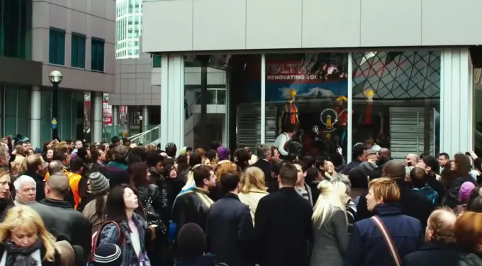 Saw 3D movie still showing a crowd gathered outside a public trap scene