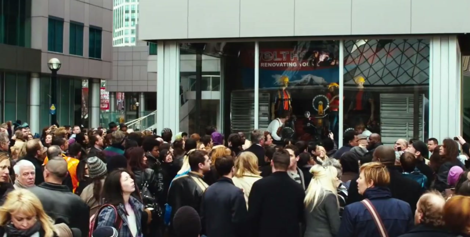 Saw 3D movie still showing a crowd gathered outside a public trap scene