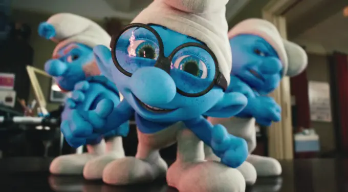 Three blue Smurfs with white hats, one frontwearing round glasses