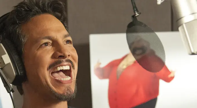 Benjamin Bratt recording voiceover with headset and microphone in studio