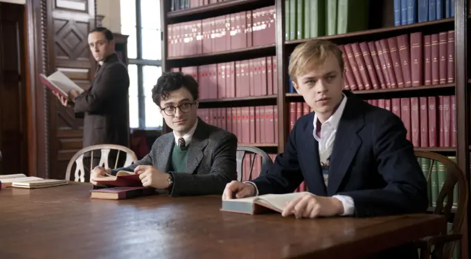 Daniel Radcliffe and Dane DeHaan sit at library table with books
