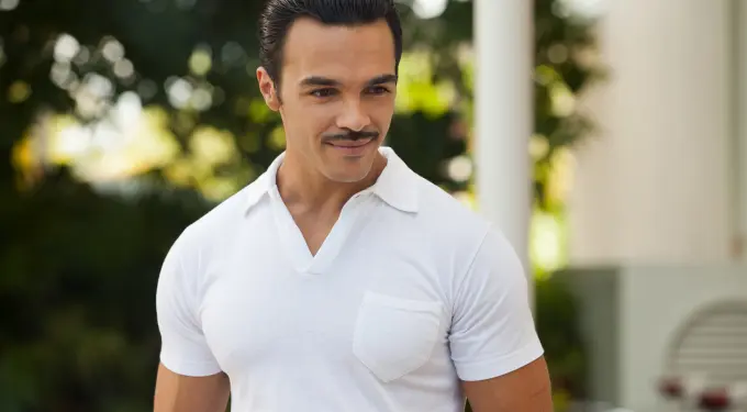 Shalim Ortiz in white shirt looking off camera outdoors