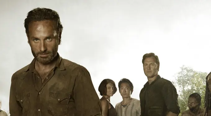Andrew Lincoln with Walking Dead cast in forest, serious expressions