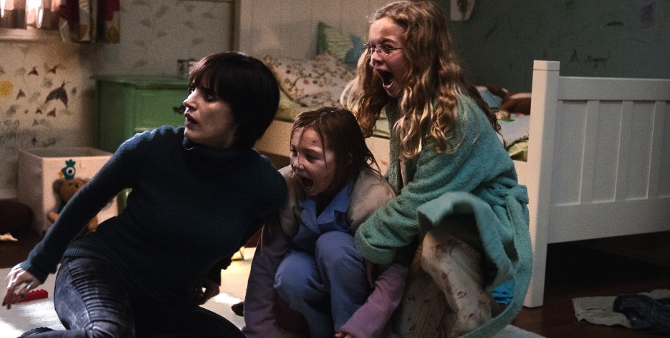 two girls and woman crouch, shouting, scared in dim bedroom