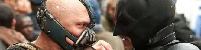 Close-up of Bane and Batman facing off, intense stare down