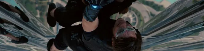 Man in tactical gear scaling glass skyscraper exterior