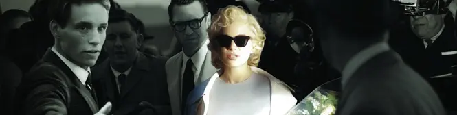 blonde woman in white dress and sunglasses amid men in suits