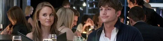 man and woman sit at restaurant table with menus in hand