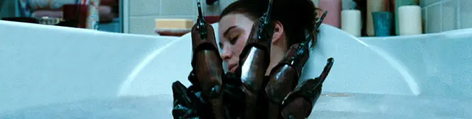 Woman in bathtub with Freddy Krueger glove near her face