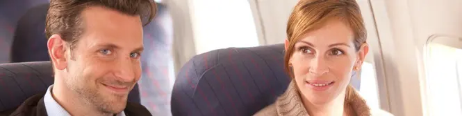 Man and woman seated side by side on an airplane