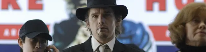 Man in black hat and suit with cigarette, flanked by two others