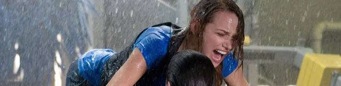 two women in rain, one woman distressed and shouting