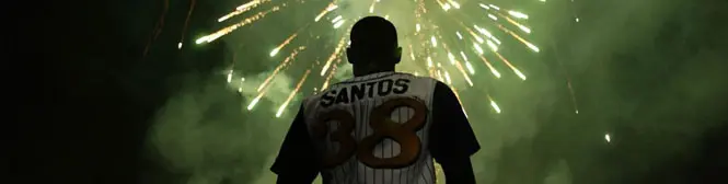 Person in Santos 38 jersey faces fireworks in night sky