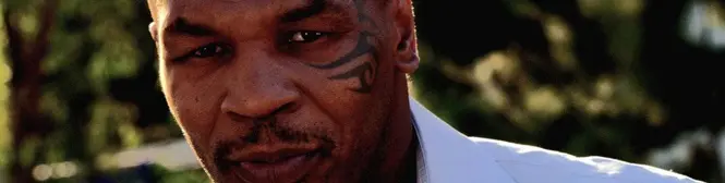 Close-up of Mike Tyson with facial tattoo outdoors in white shirt