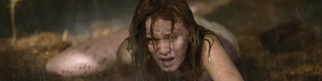 distressed woman crawling in muddy rain in a tense movie scene