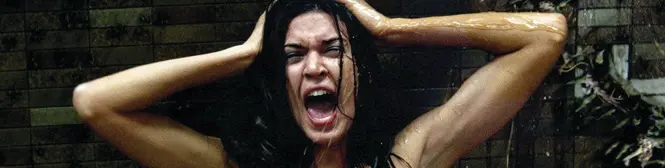 a woman screaming with wet hair holding her head in water