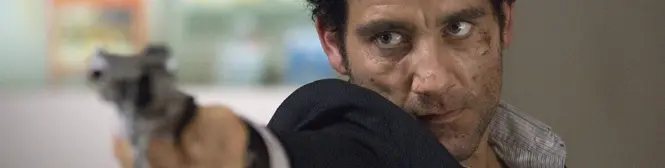 Man with grimy face aims gun intensely in close-up shot