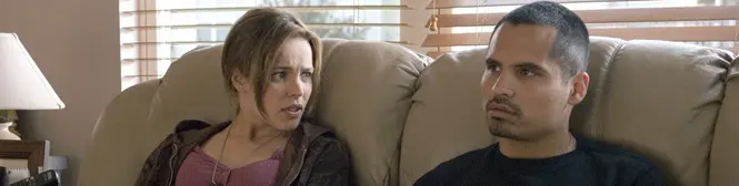 A man and woman sitting on sofa looking at each other