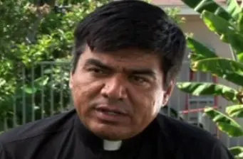 George Lopez chats from the set of Henry Poole wearing a priest’s collar.
George Lopez close-up wearing clerical collar on set of Henry Poole