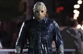 Jason Voorhees in hockey mask and dark clothes on street at night
