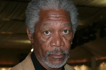 Close-up headshot of Morgan Freeman with serious expression indoors