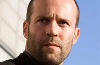 Jason Statham serious close-up with blue sky background