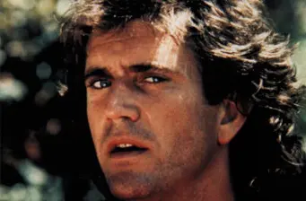 Close-up of man with curly hair and intense expression