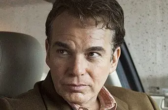 Billy Bob Thornton close-up looking sideways inside a car