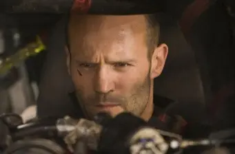 man concentrating inside a car cockpit, intense expression