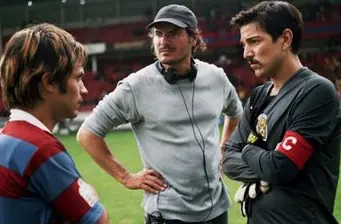 Gael García Bernal and Diego Luna with director on soccer field