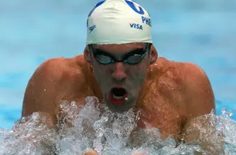 Michael Phelps swimming with goggles and swim cap in pool