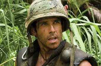 actor in combat helmet and vest in jungle scene