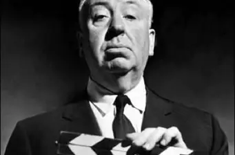 Close-up black and white photo of Alfred Hitchcock in suit and tie
