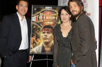 Diego Luna with two people near JC Chavez movie poster at premiere