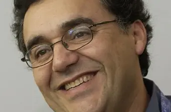 Rodrigo Garcia close-up smiling headshot with glasses