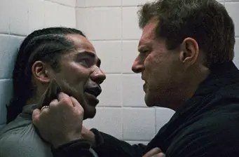Two men face off, one gripping other's collar aggressively