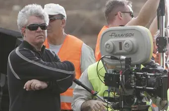 Director Pedro Almodóvar stands near Panavision camera on set