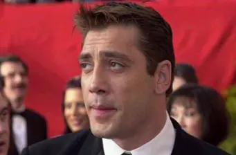Javier Bardem close-up at formal red carpet event with people behind
