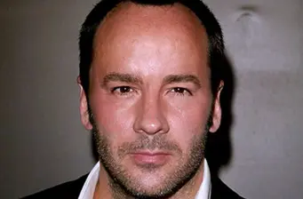 Close-up headshot of Tom Ford looking at the camera