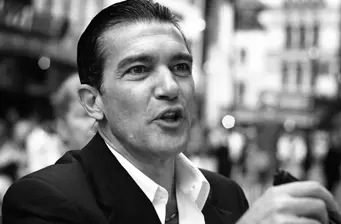 Spanish actor Antonio Banderas speaking outdoors in black and white photo