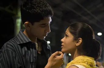 young man and woman in close conversation, man touches woman’s chin