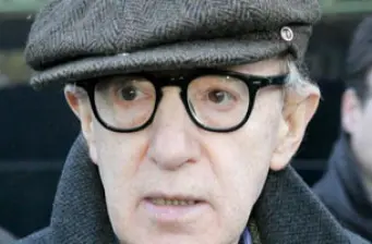 Close-up of Woody Allen wearing glasses and a gray cap