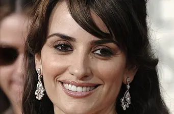 Close-up of woman smiling with long earrings at event